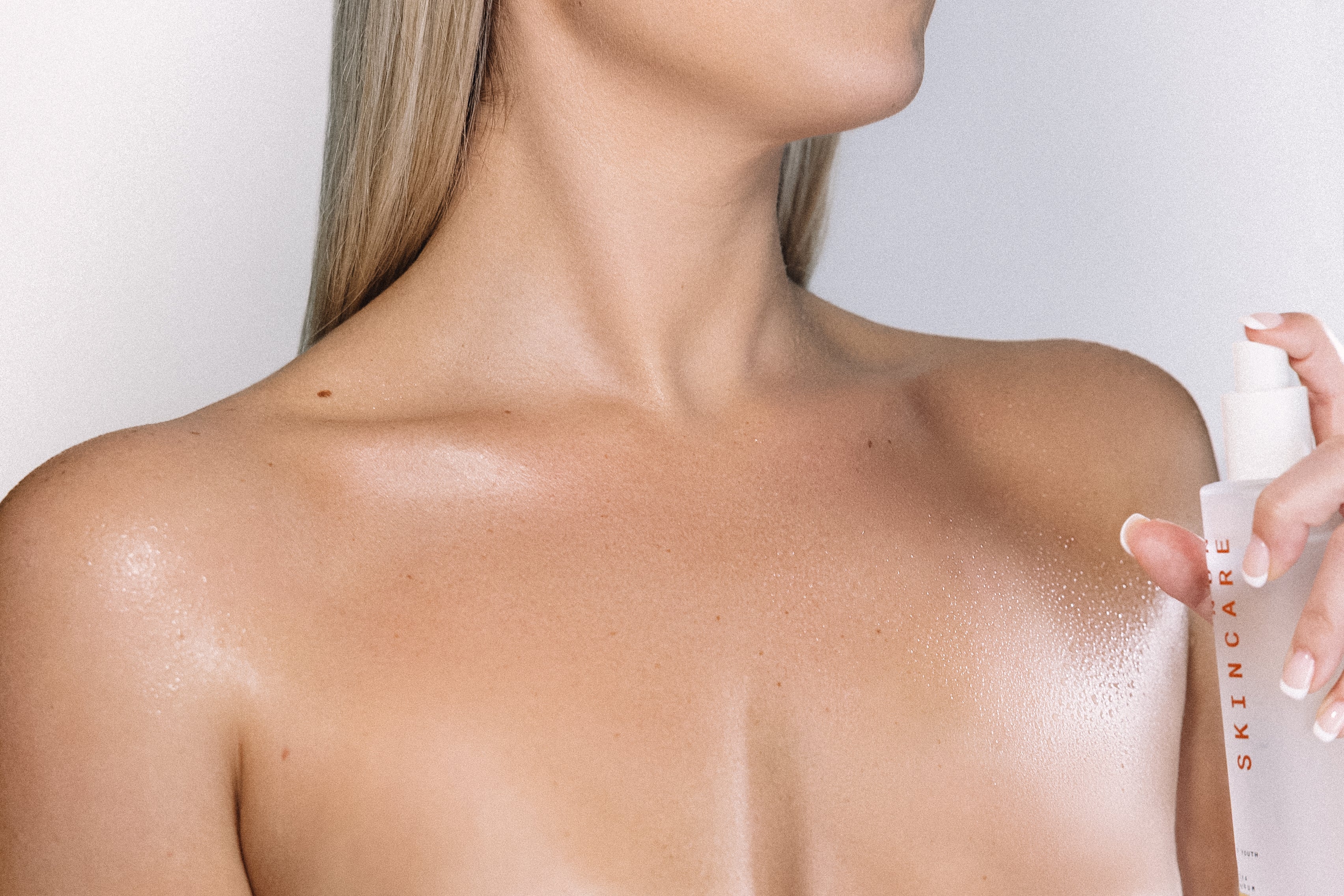 Goddess of Youth body serum misted across body skin